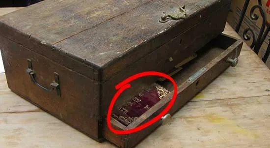 The Lost Ways leather-bound book tucked in the drawer of an old wooden chest